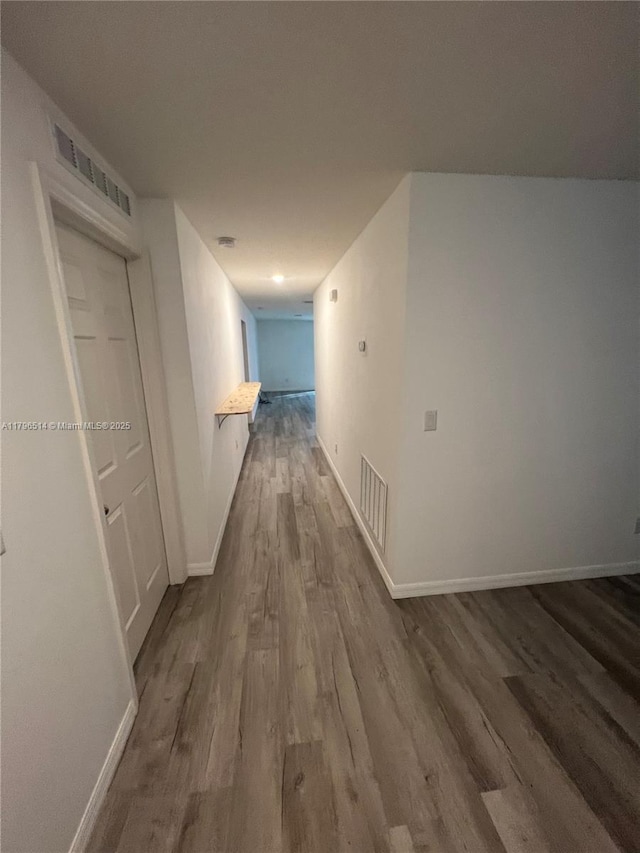 203 Palmwood Dr, Palm Coast, FL 32164 - corridor with baseboards, visible vents, and dark wood-style floors
