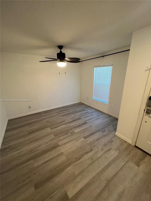 203 Palmwood Dr, Palm Coast, FL 32164 - unfurnished bedroom featuring a ceiling fan, wood finished floors, baseboards, and a textured ceiling