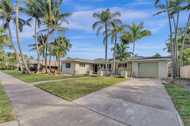 1438 Harrison St, Hollywood, FL 33020 - ranch-style house with stucco siding, a garage, concrete driveway, and a front lawn