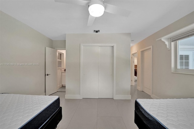 1438 Harrison St, Hollywood, FL 33020 - bedroom featuring a closet, light tile patterned floors, a ceiling fan, and baseboards