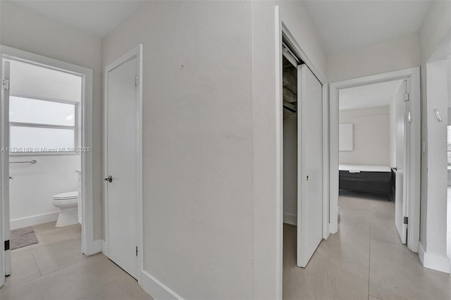 1438 Harrison St, Hollywood, FL 33020 - hall with light tile patterned flooring and baseboards