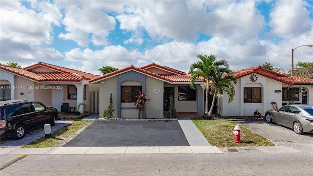 mediterranean / spanish-style home with stucco siding and a tile roof
