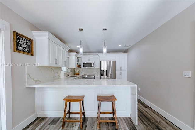 13305 SW 22nd Ter, Miami, FL 33175 - kitchen with a sink, a peninsula, stainless steel appliances, open shelves, and baseboards