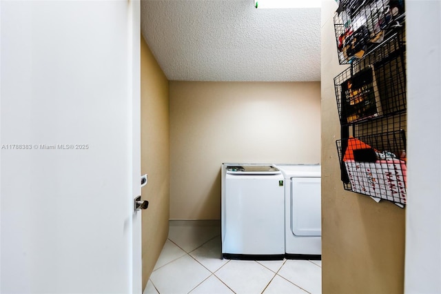 13305 SW 22nd Ter, Miami, FL 33175 - laundry area featuring washing machine and clothes dryer, laundry area, light tile patterned flooring, and a textured ceiling