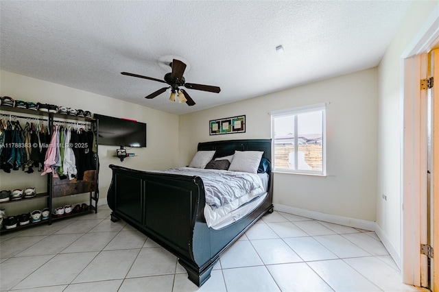 13305 SW 22nd Ter, Miami, FL 33175 - bedroom featuring a textured ceiling, baseboards, a ceiling fan, and light tile patterned floors