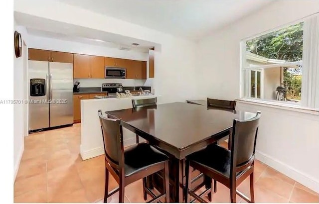 dining area featuring baseboards and light tile patterned floors