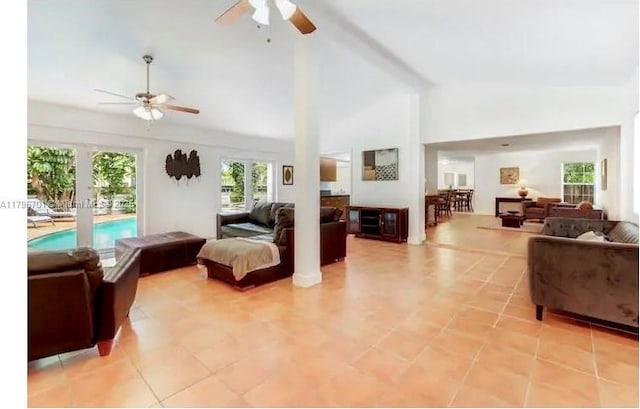 living room with french doors, ceiling fan, and high vaulted ceiling