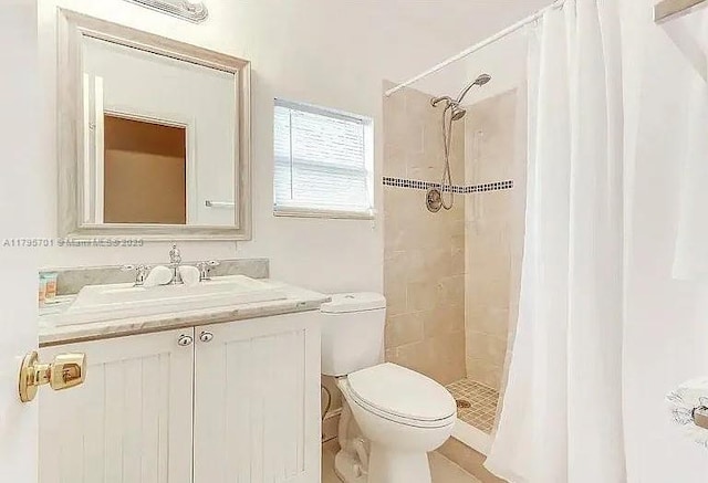 bathroom featuring a shower stall, visible vents, vanity, and toilet