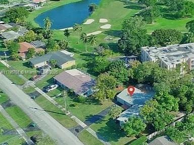 bird's eye view featuring a water view and golf course view