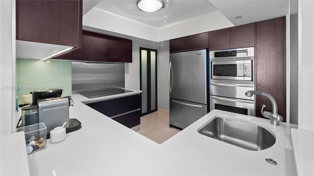1900 Sunset Harbour Dr Unit 2008, Miami Beach, FL 33139 - kitchen featuring dark brown cabinets, a sink, a warming drawer, light countertops, and appliances with stainless steel finishes