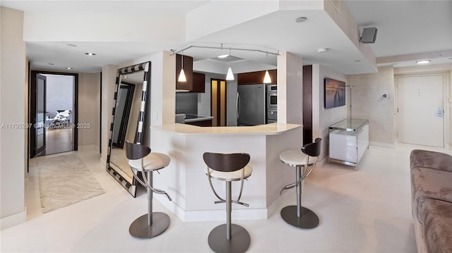 1900 Sunset Harbour Dr Unit 2008, Miami Beach, FL 33139 - kitchen featuring a peninsula, light countertops, appliances with stainless steel finishes, and a breakfast bar
