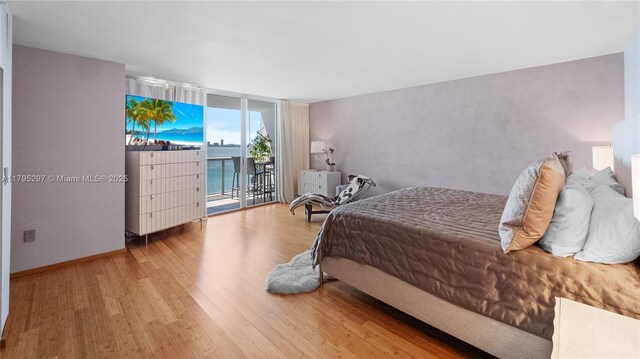 1900 Sunset Harbour Dr Unit 2008, Miami Beach, FL 33139 - bedroom with floor to ceiling windows, access to outside, and wood finished floors