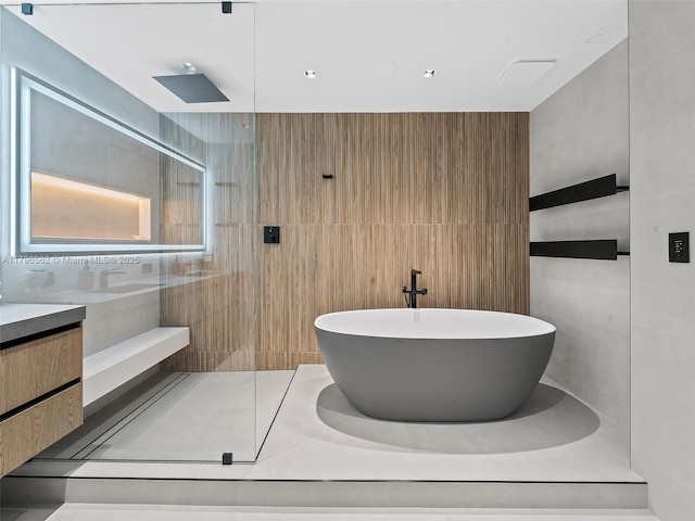 3101 S Ocean Dr Unit 2905, Hollywood, FL 33019 - bathroom featuring tile walls, a walk in shower, a freestanding tub, and vanity