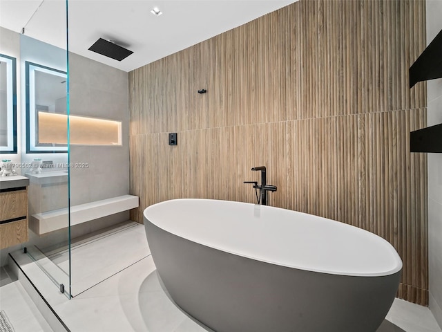 3101 S Ocean Dr Unit 2905, Hollywood, FL 33019 - bathroom with tile walls, a walk in shower, a soaking tub, vanity, and tile patterned floors