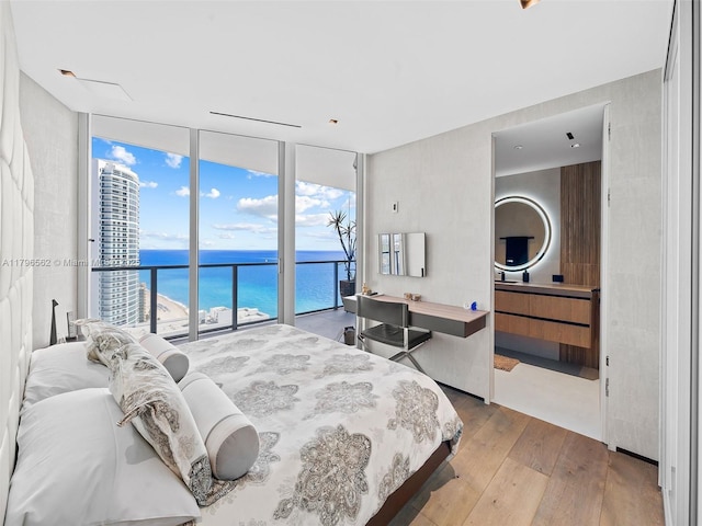 3101 S Ocean Dr Unit 2905, Hollywood, FL 33019 - bedroom with a wall of windows, access to outside, a water view, and wood-type flooring