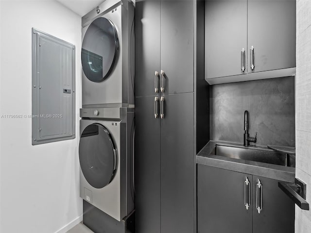3101 S Ocean Dr Unit 2905, Hollywood, FL 33019 - laundry room featuring stacked washer / drying machine, cabinet space, electric panel, and baseboards
