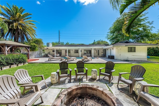 view of patio / terrace featuring an outdoor fire pit, a gazebo, and an outdoor pool