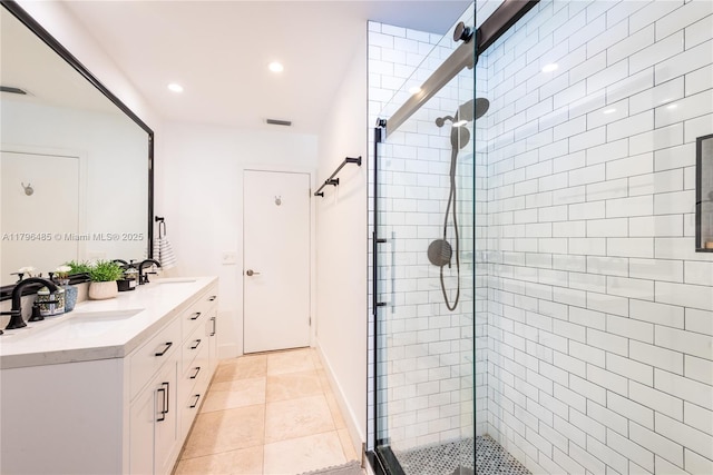 bathroom with a stall shower, recessed lighting, visible vents, a sink, and double vanity