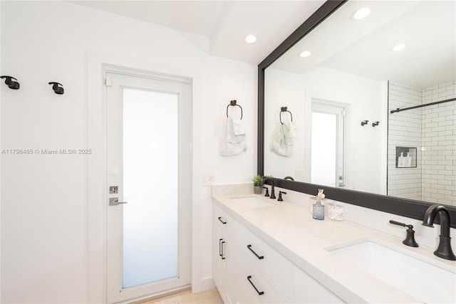 full bath featuring recessed lighting, walk in shower, and a sink