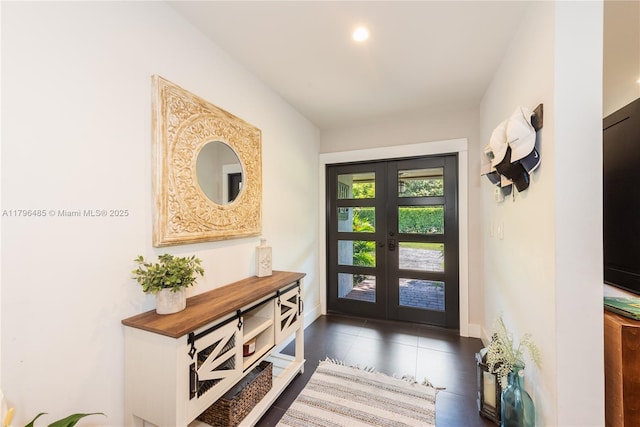entryway featuring baseboards, french doors, and tile patterned floors