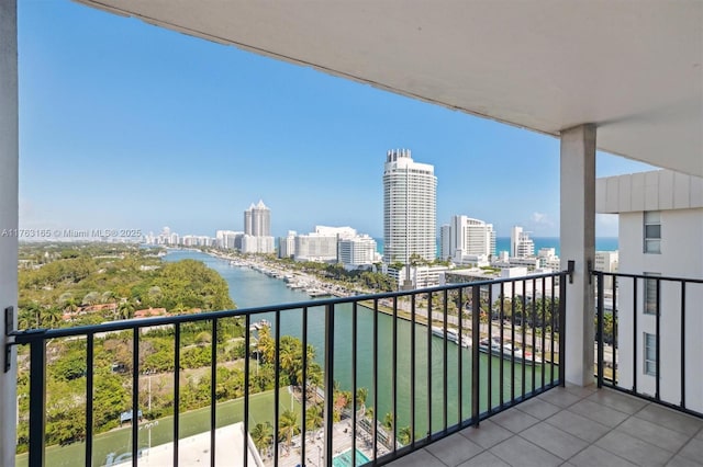 balcony featuring a water view and a city view