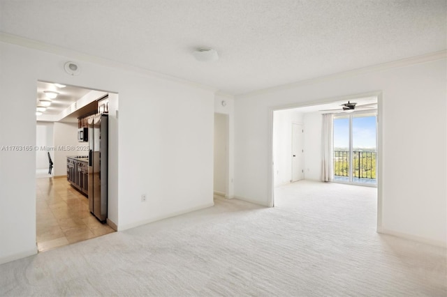 empty room with light colored carpet and crown molding