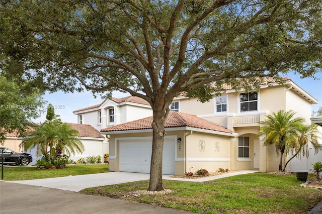 view of front of home with concrete driveway, a front yard, a tiled roof, and an attached garage