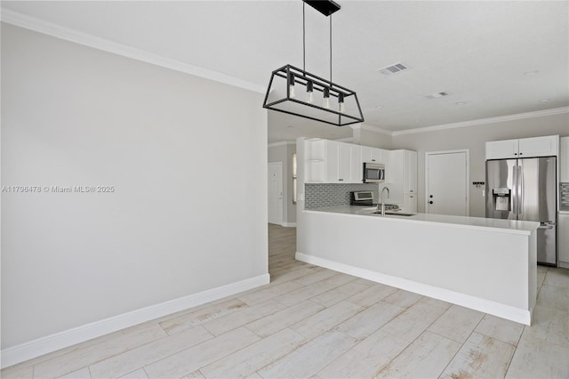 kitchen featuring white cabinetry, ornamental molding, stainless steel appliances, and visible vents