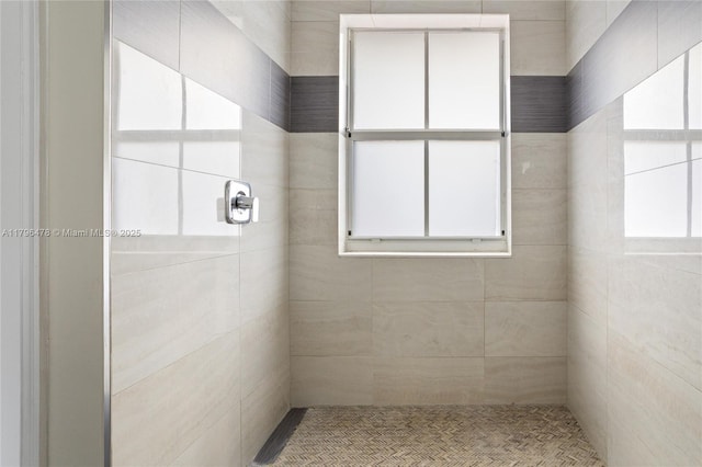 full bath with a tile shower