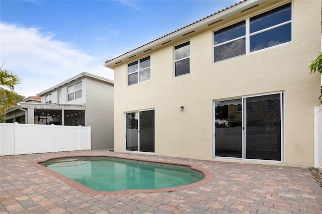 view of swimming pool featuring a patio, a fenced in pool, and fence