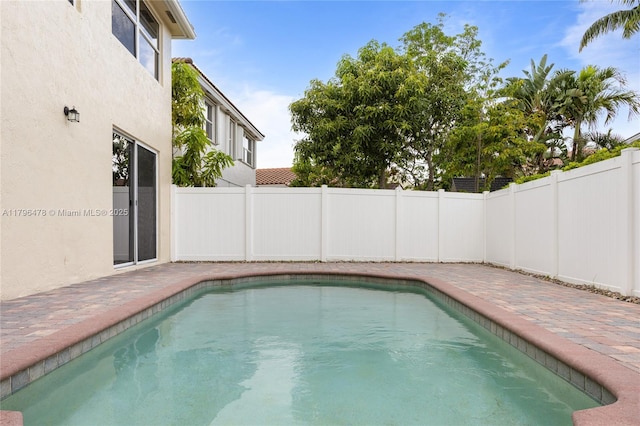 view of swimming pool with a fenced backyard, a patio, and a fenced in pool
