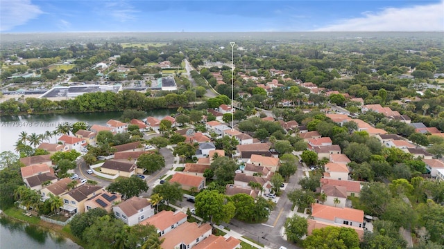 birds eye view of property with a water view and a residential view