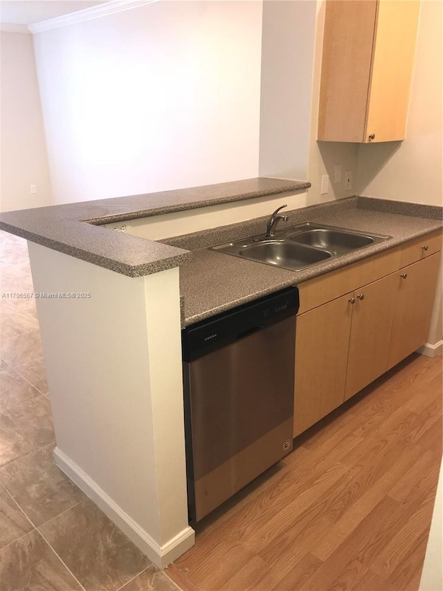 kitchen with dishwasher, a sink, a peninsula, crown molding, and light wood-type flooring