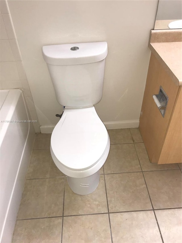 bathroom featuring tile patterned floors, toilet, and baseboards