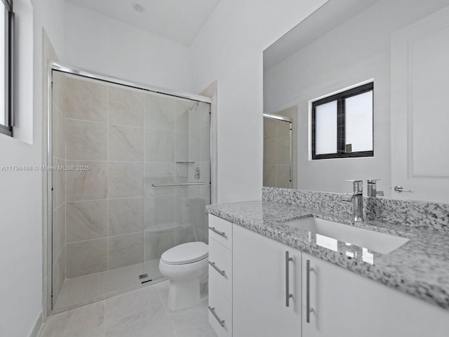 full bathroom featuring vanity, toilet, a shower stall, and tile patterned floors