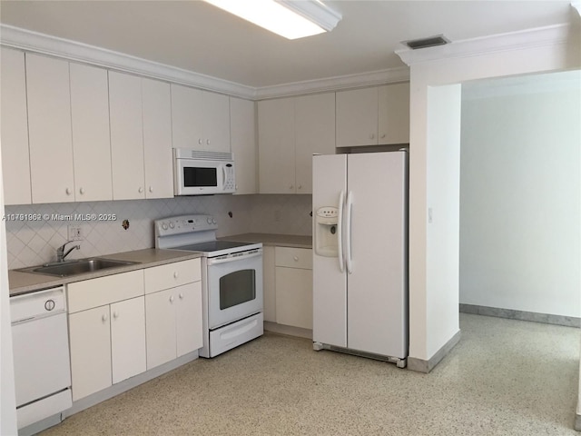 kitchen with a sink, crown molding, visible vents, white appliances, and decorative backsplash