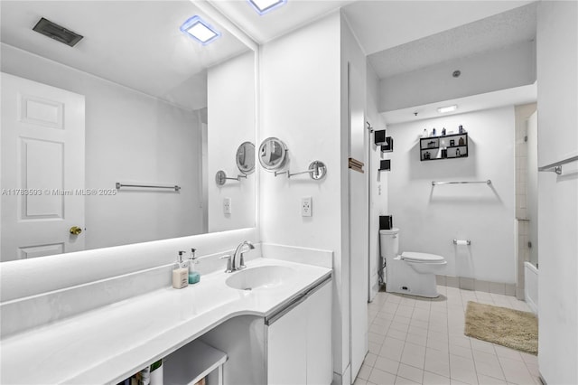 bathroom with toilet, vanity, visible vents, tile patterned flooring, and tub / shower combination