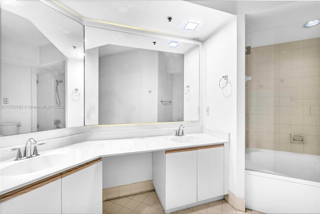 bathroom featuring a sink, double vanity, and tile patterned floors
