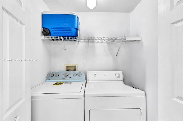 clothes washing area featuring laundry area and washer and clothes dryer