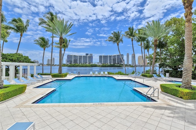 pool featuring a patio, a water view, a pergola, and a view of city