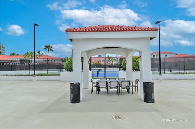 view of patio with outdoor dining area and fence