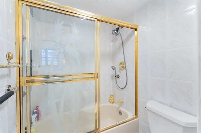 bathroom with enclosed tub / shower combo, tile walls, and toilet