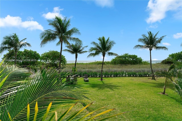 surrounding community featuring a yard and fence