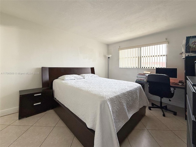 bedroom with baseboards and light tile patterned flooring