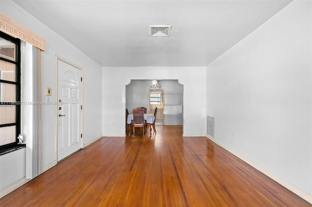 interior space with visible vents, wood finished floors, and baseboards