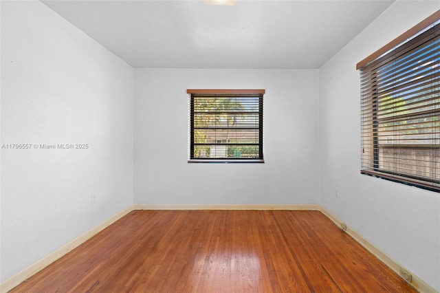 empty room with wood finished floors and baseboards