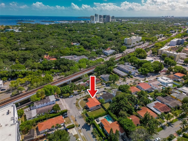 birds eye view of property featuring a water view and a view of city