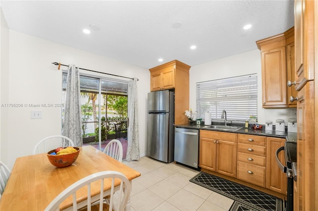 1249 NW 126th Ter, Sunrise, FL 33323 - kitchen featuring stainless steel appliances, a sink, dark countertops, light tile patterned flooring, and recessed lighting