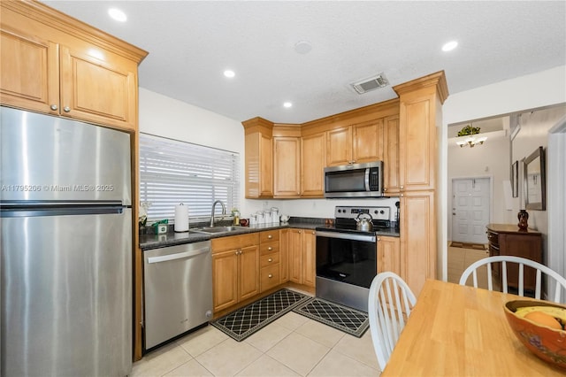 1249 NW 126th Ter, Sunrise, FL 33323 - kitchen featuring stainless steel appliances, a sink, light tile patterned flooring, dark countertops, and recessed lighting