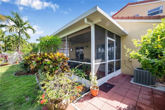 1249 NW 126th Ter, Sunrise, FL 33323 - view of home's exterior featuring a sunroom, stucco siding, central AC unit, and a patio area